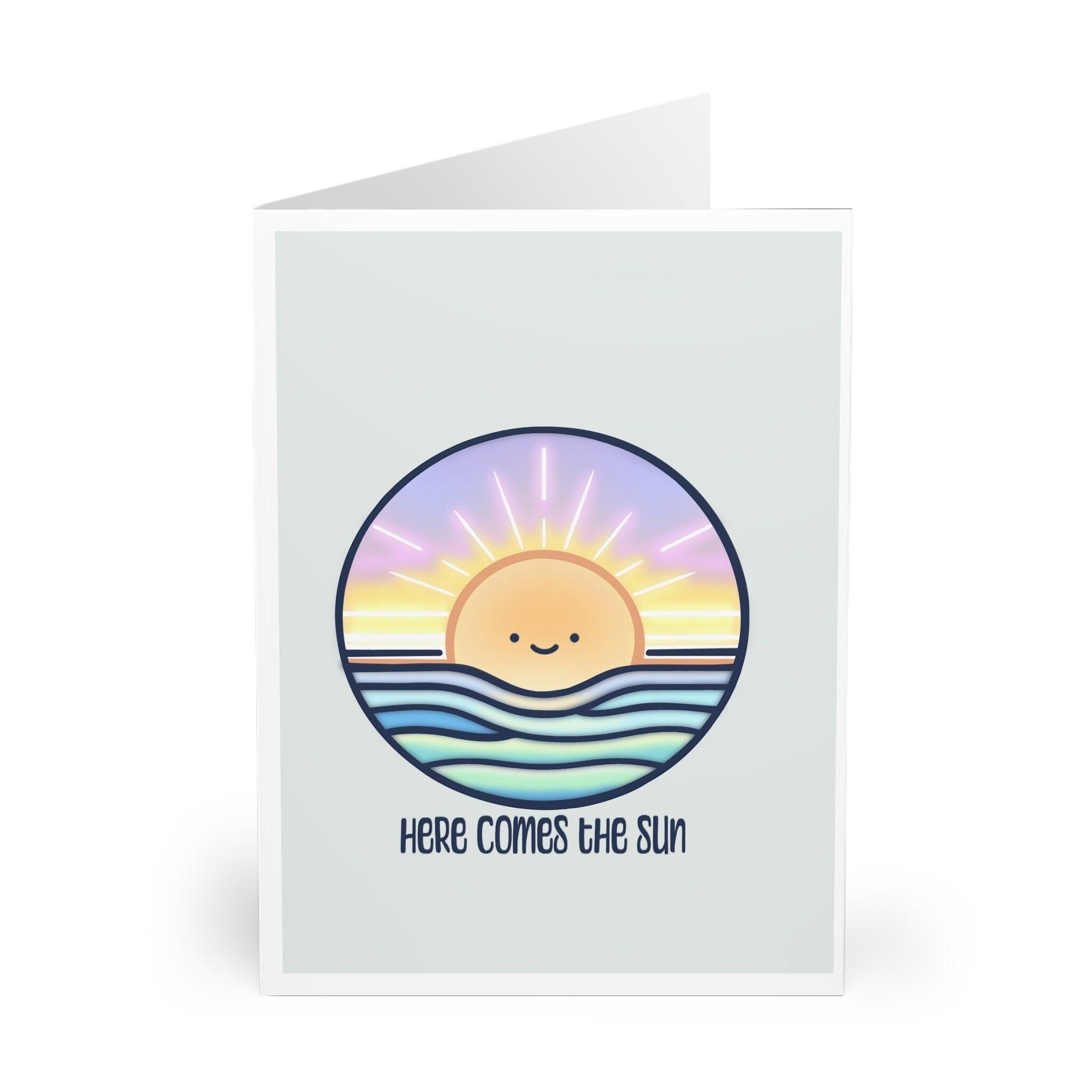 right and cheerful greeting card featuring a smiling sun with the phrase 'Here Comes the Sun.' A warm and positive card perfect for celebrating good news or sending a sunny greeting - Baby Keo