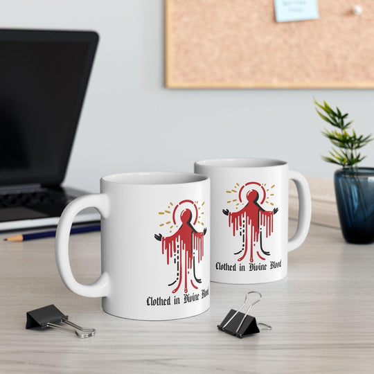 Bold white ceramic mug featuring a dramatic dripping red design with the text 'Clothed in Divine Blood,' perfect for a striking and gothic aesthetic