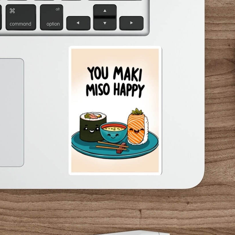 A sticker with the phrase 'You Maki Miso Happy' and an illustration of sushi placed on a laptop.