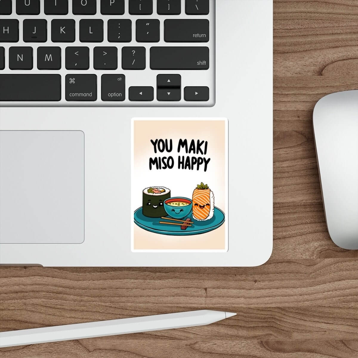 A sticker with the phrase 'You Maki Miso Happy' and an illustration of sushi placed on a laptop.