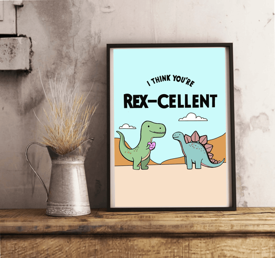 Add a touch of prehistoric charm to your space with a delightful framed illustration from the "Rex-cellent Adventures: Dinosaur Print" collection! This playful piece features two adorable cartoon dinosaurs—a cheerful green T-Rex holding a purple flower, and a friendly blue stegosaurus sporting pink plates. The whimsical scene is set against a backdrop of light blue sky, with the heartwarming phrase, "I think you're Rex-cellent," written above. Perfectly placed on a wooden floor, this charming dinosaur artwo