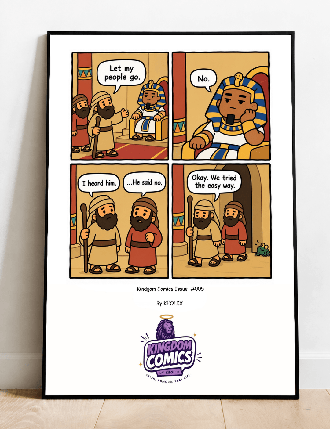 A framed comic art print titled 'Kingdom Comics Tissue #905' by Yegolak, leaning against a wall on a light wood floor. The print features a four-panel cartoon scene depicting biblical figures in an ancient Egyptian-style setting, with a white border and the Kingdom Comics logo at the bottom.