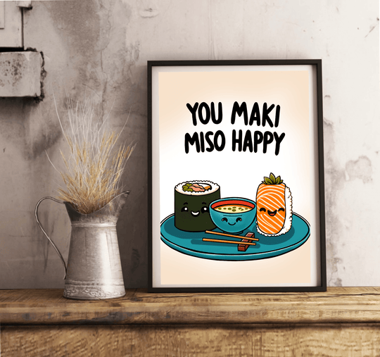 Introducing the delightful "You Maki Miso Happy" Artwork Print! This charming piece features an adorable illustration of beaming sushi rolls alongside a cheerful miso soup bowl, all perfectly perched on a teal plate with chopsticks at the ready. Above this joyful scene, you'll find the playful phrase "You maki miso happy" in bold black letters, adding a fun touch to any room. Set against a soft beige backdrop, this framed print elegantly rests on a wooden floor, ready to bring warmth and smiles to your spac