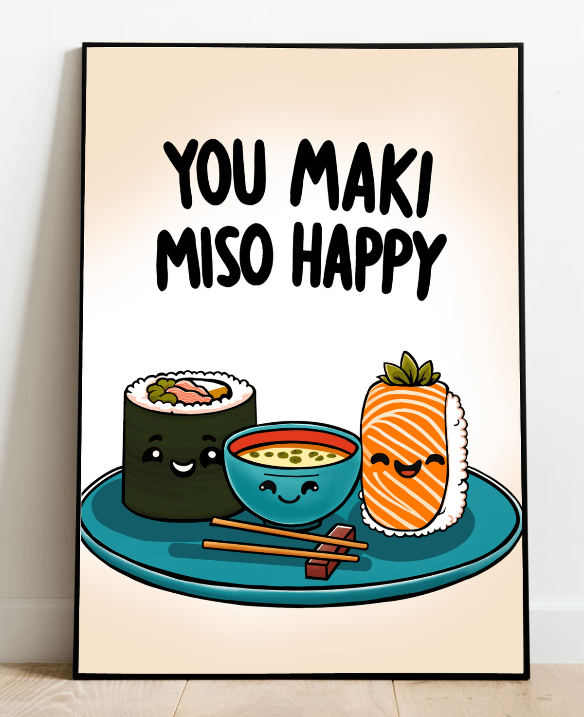 Introducing the delightful "You Maki Miso Happy" Artwork Print! This charming piece features an adorable illustration of beaming sushi rolls alongside a cheerful miso soup bowl, all perfectly perched on a teal plate with chopsticks at the ready. Above this joyful scene, you'll find the playful phrase "You maki miso happy" in bold black letters, adding a fun touch to any room. Set against a soft beige backdrop, this framed print elegantly rests on a wooden floor, ready to bring warmth and smiles to your spac