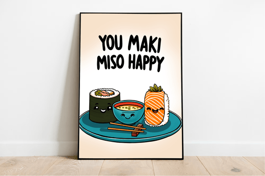 Introducing the delightful "You Maki Miso Happy" Artwork Print! This charming piece features an adorable illustration of beaming sushi rolls alongside a cheerful miso soup bowl, all perfectly perched on a teal plate with chopsticks at the ready. Above this joyful scene, you'll find the playful phrase "You maki miso happy" in bold black letters, adding a fun touch to any room. Set against a soft beige backdrop, this framed print elegantly rests on a wooden floor, ready to bring warmth and smiles to your spac