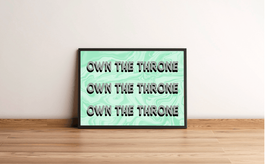 Picture this: a stunning Own the Throne Print, framed with top-notch quality, leaning effortlessly against a crisp white wall on a charming wooden floor. This eye-catching piece of art features a chic mint green marble pattern as its backdrop, while the bold black letters spell out "OWN THE THRONE" three times in an all-caps blocky font. It's not just décor—it's your statement of style!