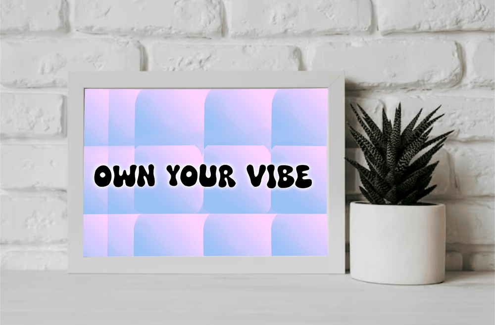 Meet your new favorite piece of décor: a stunning "Own Your Vibe Print" that’s sure to brighten up any space! Resting elegantly on a wooden floor and leaning comfortably against a simple wall, this framed print showcases its high-gloss finish with flair. The bold, black typography shouts "OWN YOUR VIBE" across a playful checkered canvas of pastel pink and blue. This vibrant piece isn’t just art; it’s an invitation to embrace your unique energy every day. Perfect for adding personality to your room or office