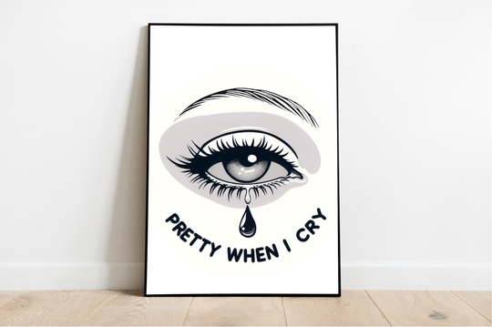 Introducing the "Pretty When I Cry" print—an eye-catching piece of art that brings a pop of emotion to any space! Featuring a beautifully illustrated crying eye with fluttery long lashes and a striking eyebrow, this print stands out against its backdrop. The phrase "Pretty When I Cry" is artfully displayed in bold, curved letters beneath the teardrop, adding an extra layer of charm. Whether leaning against a white wall or resting on light wooden flooring, this framed artwork is sure to elevate your decor. W