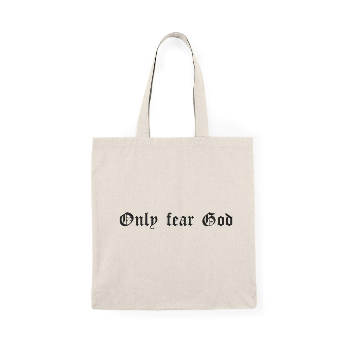 A cream tote bag featuring the bold statement 'Only Fear God' in a striking font. This simple yet powerful design resonates with those who appreciate faith-based messages, making it a meaningful accessory for daily use