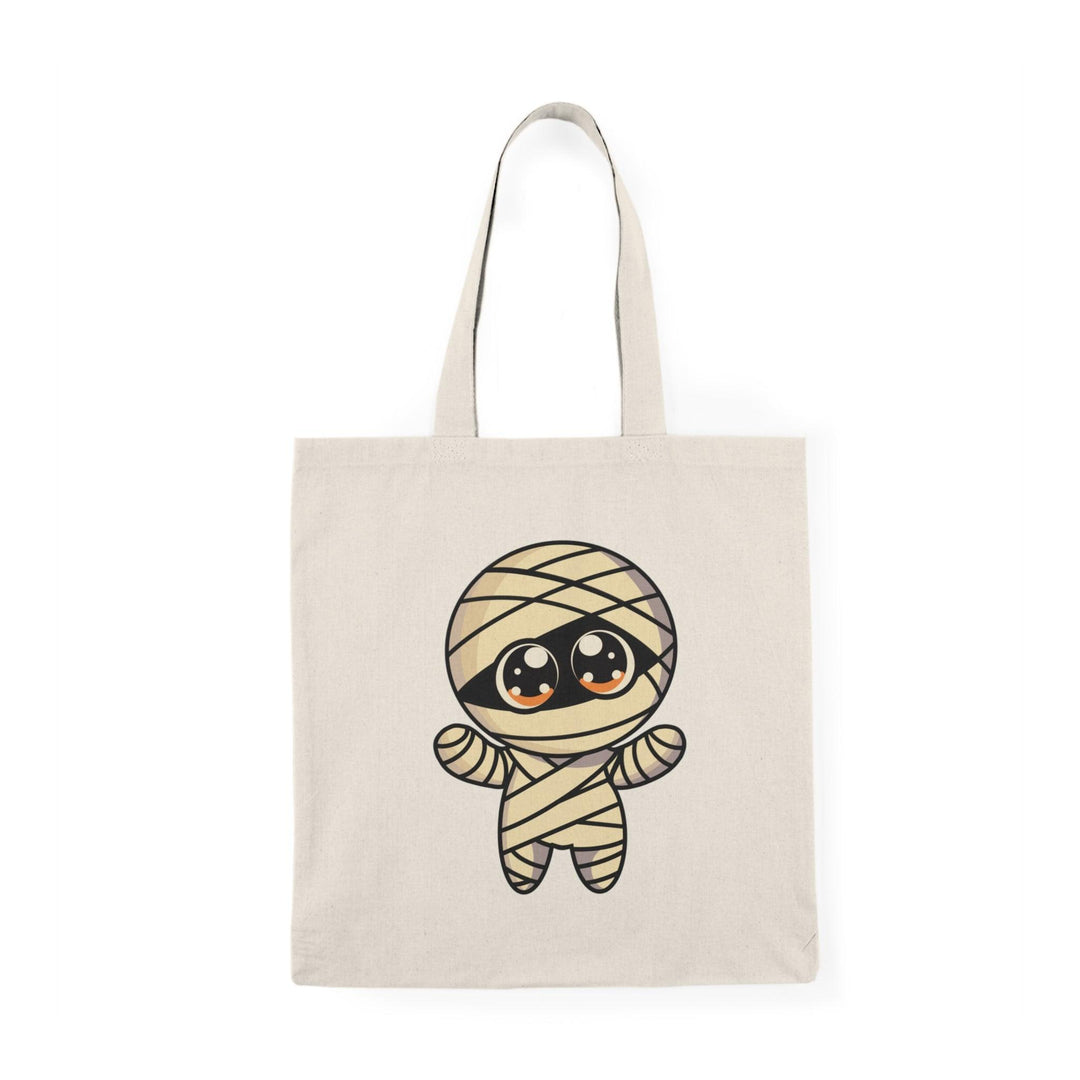 Tote bag featuring a fun and spooky design of a cartoon mummy wrapped in bandages, with a playful expression. The vibrant colors and Halloween-themed graphics make it a perfect accessory for celebrating the spooky season, ideal for carrying treats or everyday essentials
