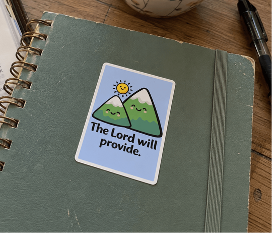 A green spiral-bound notebook with a sticker that reads &
