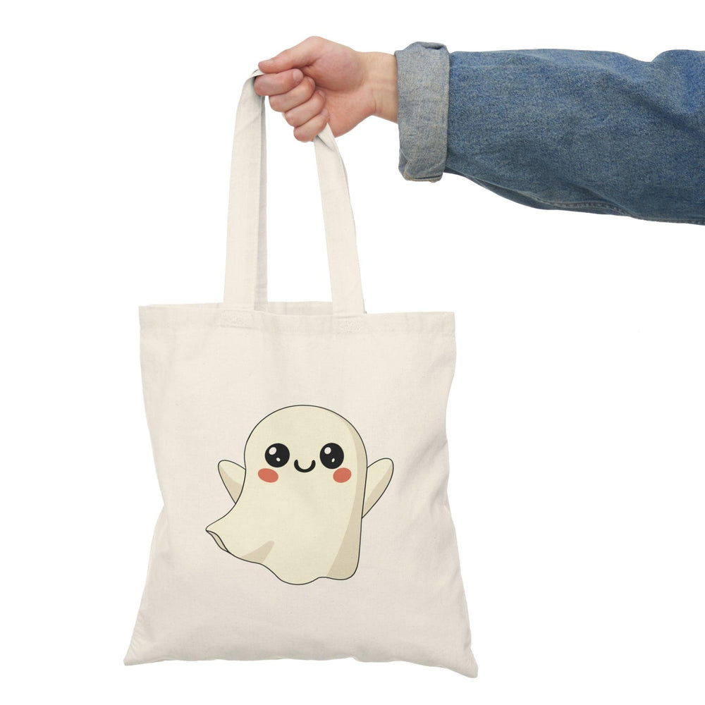 Tote bag featuring an adorable illustration of a cute ghost with a friendly smile and playful details. The whimsical design and soft colors create a charming accessory perfect for celebrating Halloween or adding a touch of spookiness to everyday style