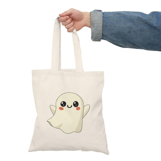 Tote bag featuring an adorable illustration of a cute ghost with a friendly smile and playful details. The whimsical design and soft colors create a charming accessory perfect for celebrating Halloween or adding a touch of spookiness to everyday style