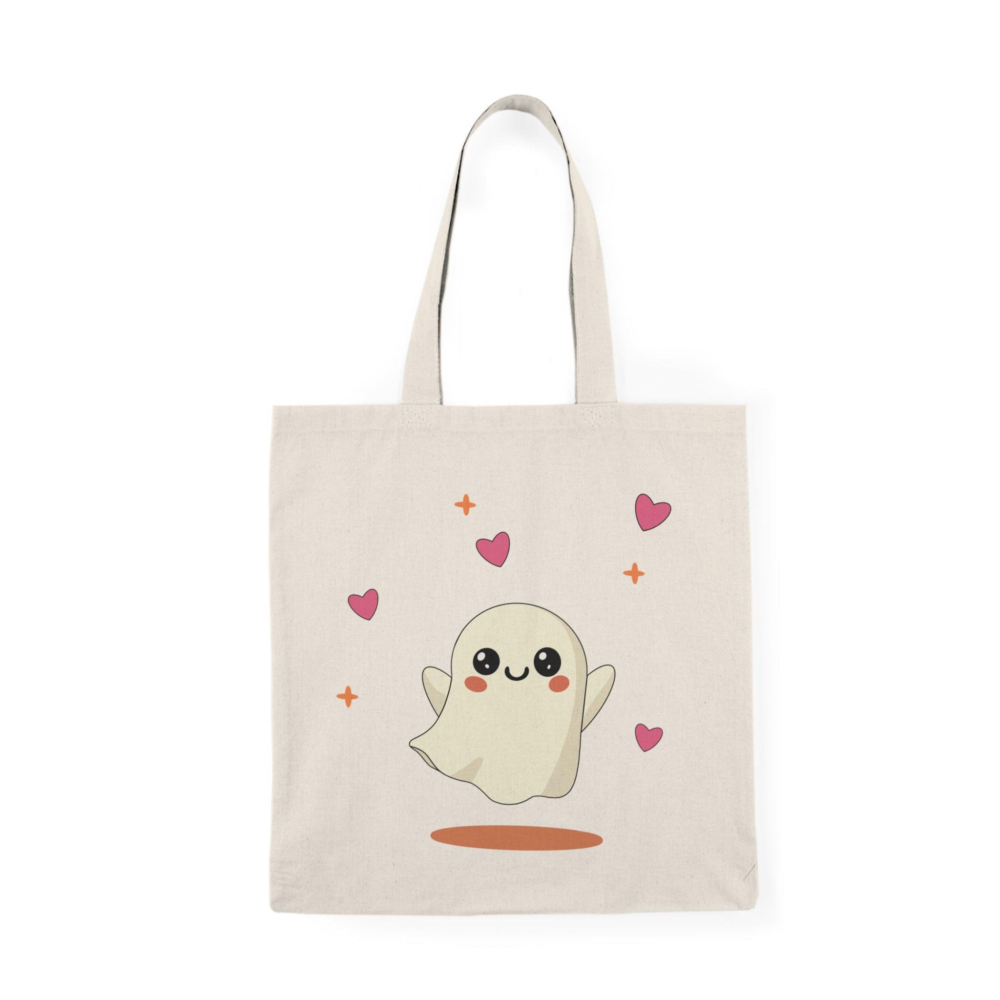 Tote bag featuring an adorable illustration of a cute ghost with a friendly smile and playful details. The whimsical design and soft colors create a charming accessory perfect for celebrating Halloween or adding a touch of spookiness to everyday style