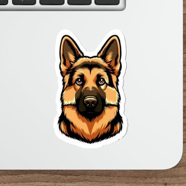 A cartoon sticker of a German Shepherd pasted on a laptop next to a computer mouse.