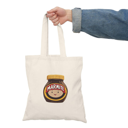 Tote bag featuring a playful illustration of a cute Marmite jar with a happy face, surrounded by whimsical graphics. The fun design and vibrant colors make it a delightful accessory for Marmite lovers, adding a touch of humor and personality to everyday carry.