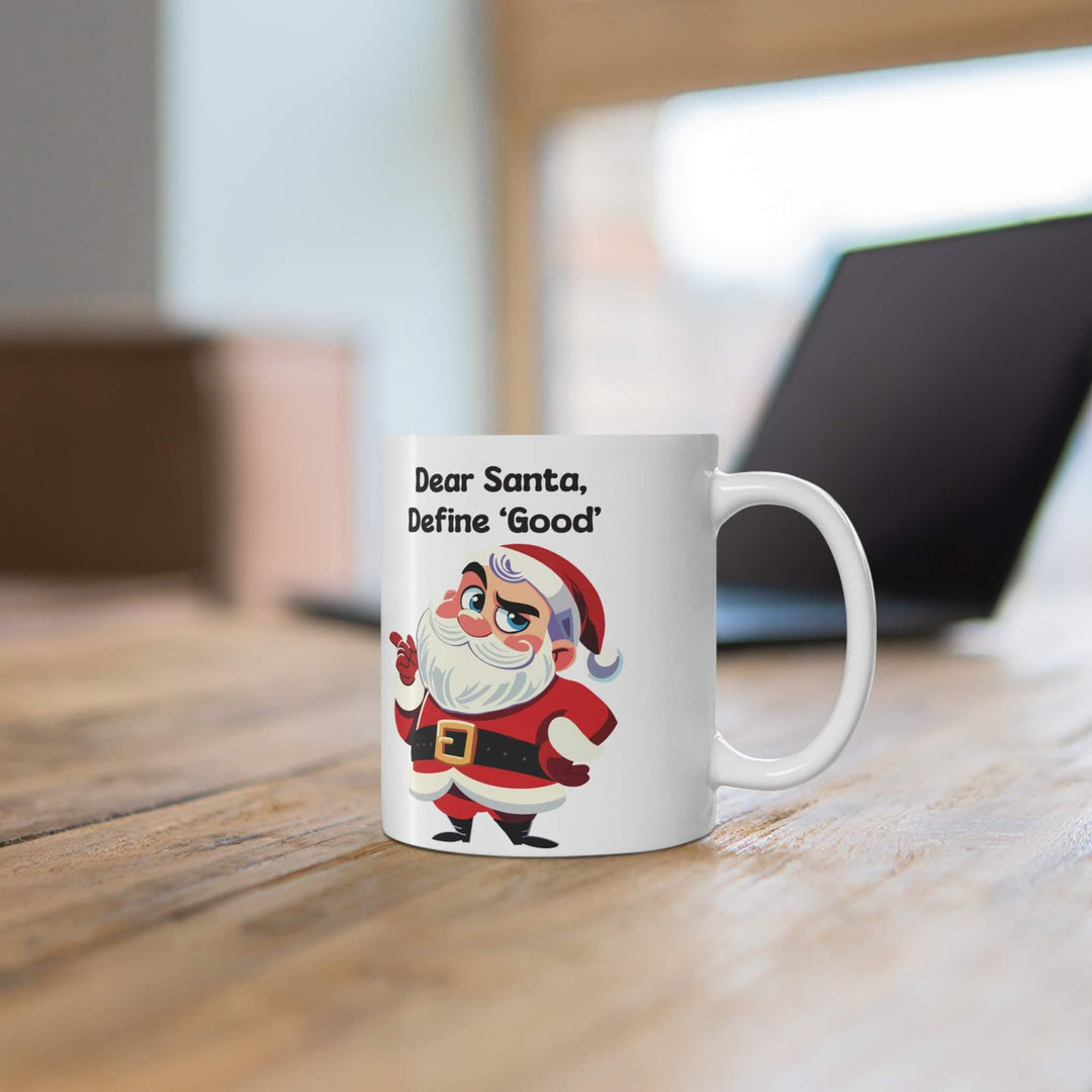 Funny Christmas mug featuring a cheeky Santa with the phrase 'Dear Santa, Define Good,' perfect for holiday coffee or hot chocolate. Available in 11oz and 15oz sizes, ideal for adding a humorous twist to Christmas decor.