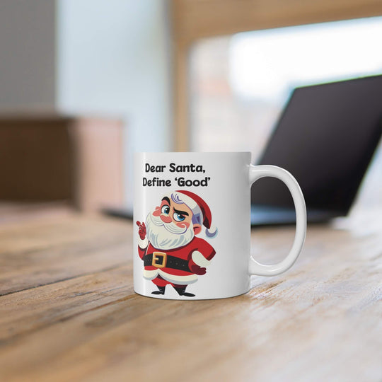 Funny Christmas mug featuring a cheeky Santa with the phrase 'Dear Santa, Define Good,' perfect for holiday coffee or hot chocolate. Available in 11oz and 15oz sizes, ideal for adding a humorous twist to Christmas decor.