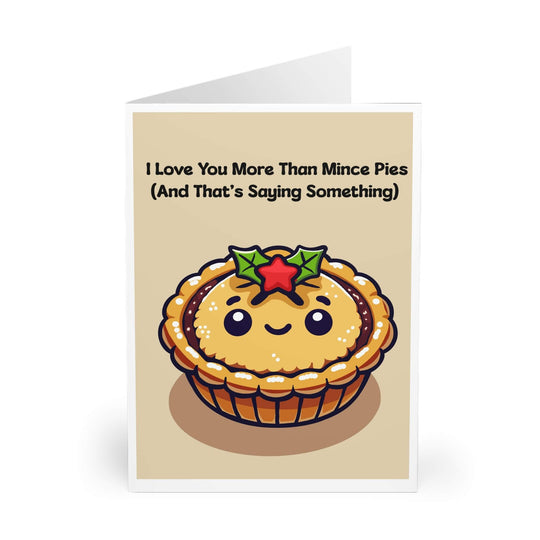 A greeting card with a cute illustration of a smiling mince pie with holly on top. The text on the card reads &