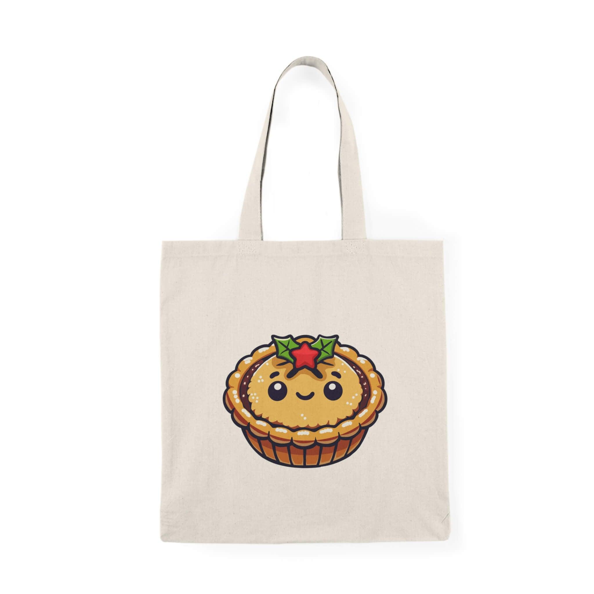Cute mince pie tote bag with a smiling mince pie and holly design, perfect for holiday shopping or as a festive accessory. Made from 100% recycled cotton with a size of 40 x 38 cm (15.7 x 15 inches) and 130-135 gsm thickness, this eco-friendly tote is both durable and charming