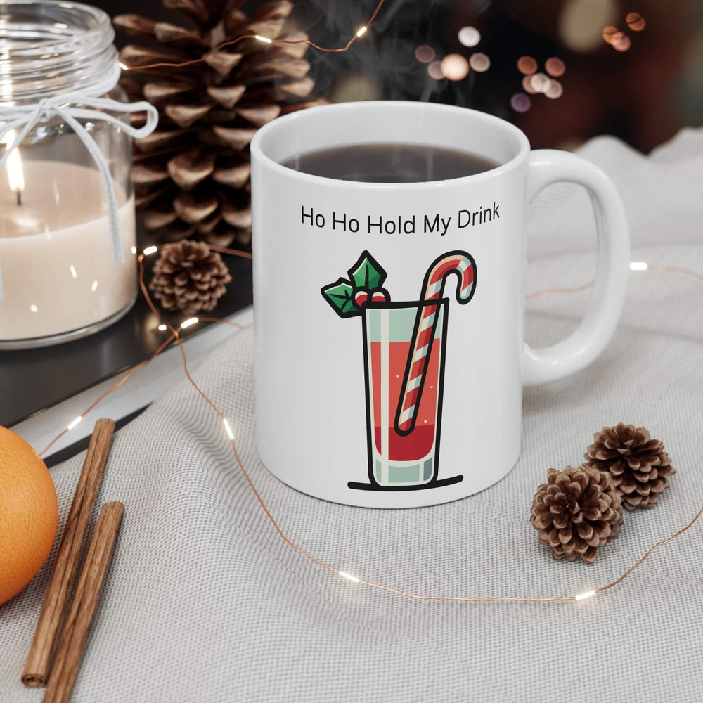 Ho Ho Hold My Drink’ 11oz ceramic Christmas cocktail mug with festive drink, candy cane stirrer, and holly, perfect for holiday sips