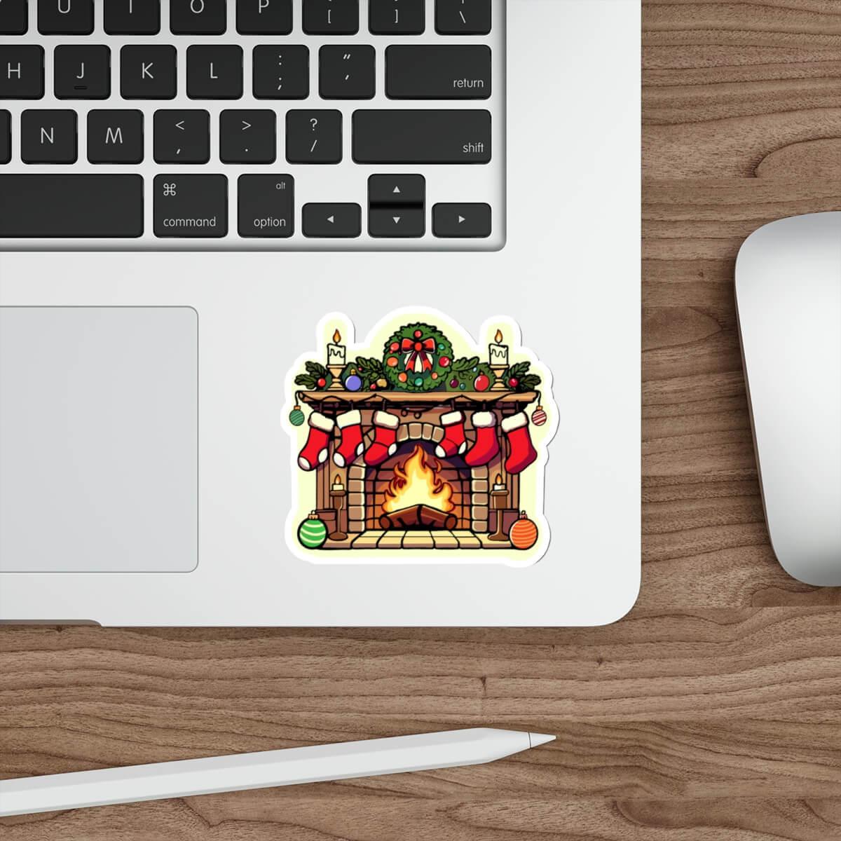 Christmas fireplace sticker on a laptop, featuring a decorated holiday fireplace with stockings, wreath, and glowing candles