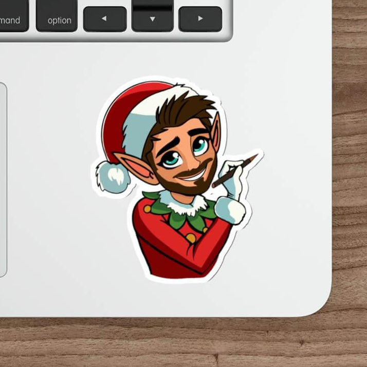 A festive sticker featuring a charming Christmas elf with a red Santa hat, green elf attire, and a playful pose. Displayed on a laptop for a stylish and fun holiday vibe. Available as a single sticker or in packs of three or six.