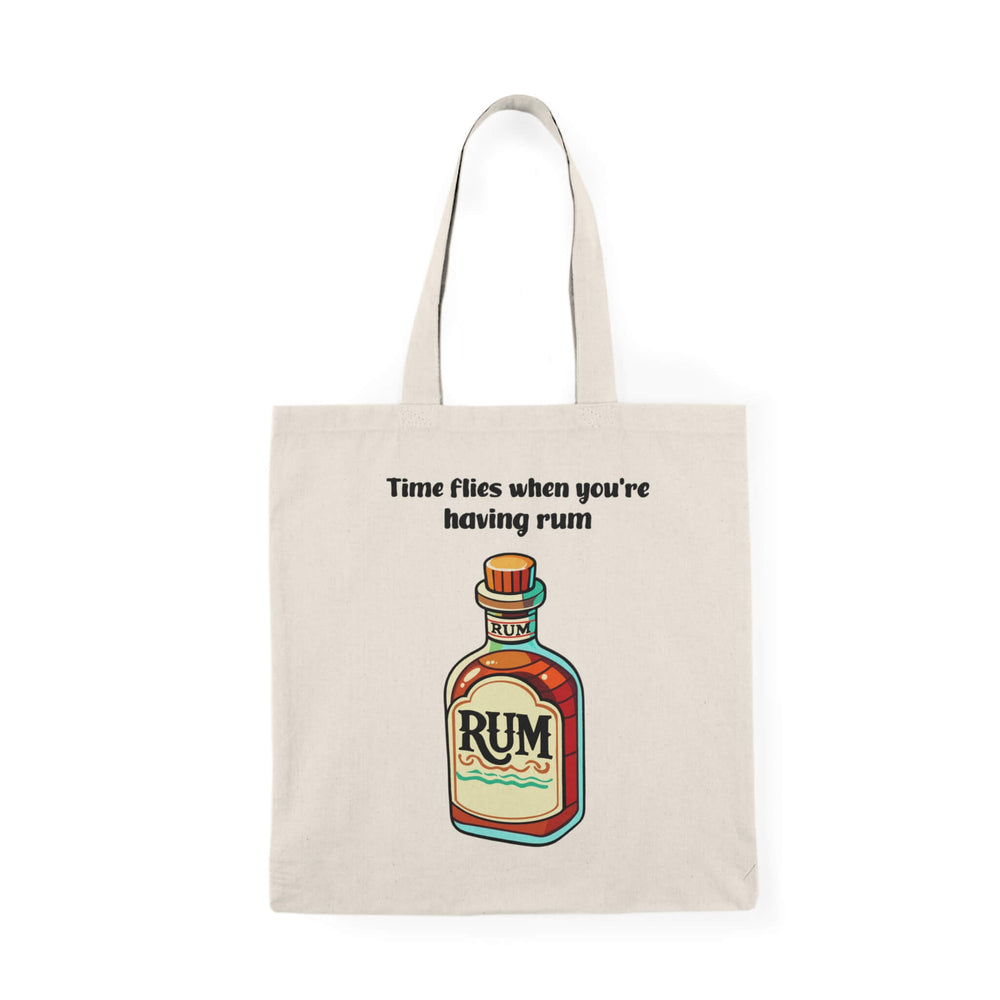 A natural-colored tote bag featuring a colorful illustration of a rum bottle with the text "Time flies when you're having rum," made from 100% recycled cotton.