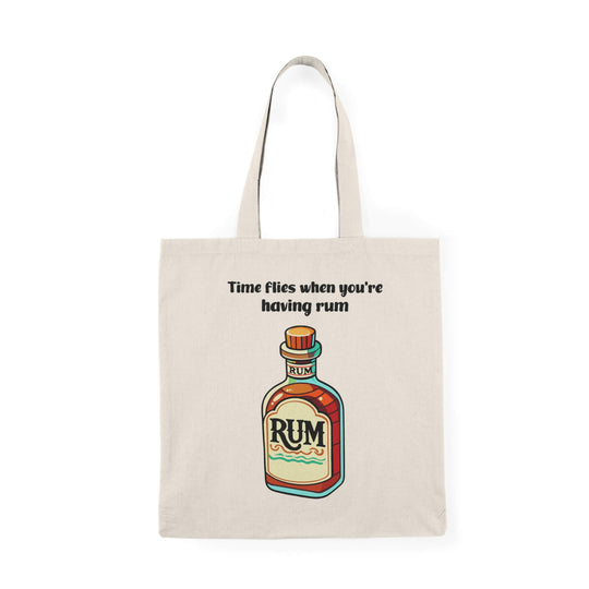 A natural-colored tote bag featuring a colorful illustration of a rum bottle with the text "Time flies when you're having rum," made from 100% recycled cotton.