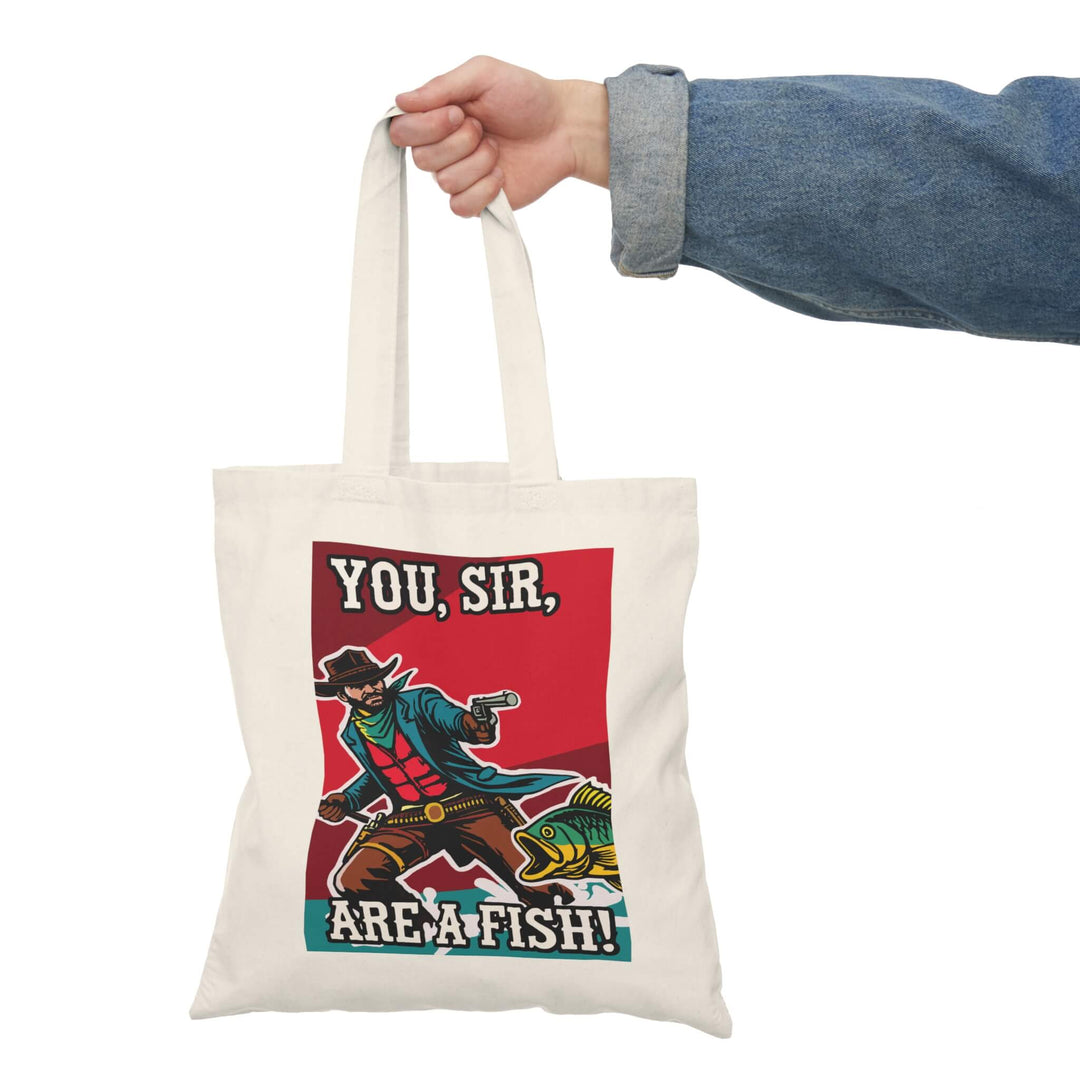 A quirky tote bag featuring a bold cowboy design with the text "You, Sir, Are a Fish!" Made from 100% recycled cotton, lightweight yet durable, perfect for carrying everyday essentials.