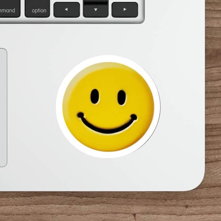Waterproof and durable smiling face sticker on a laptop keyboard, adding a touch of cheer to everyday tech accessories.