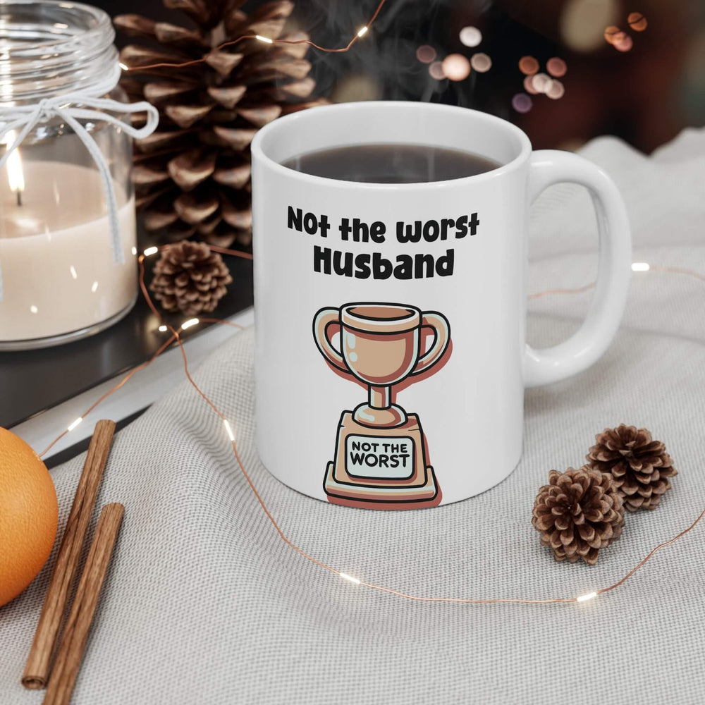 White ceramic mug with 'Not the Worst Dad' and a trophy design, ideal for gifting, 11 oz capacity, microwave and dishwasher safe.