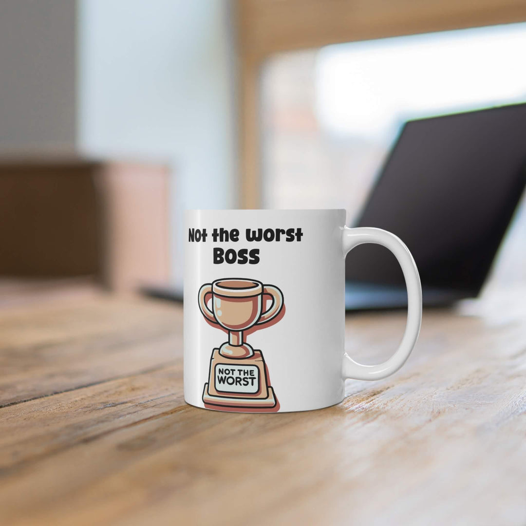 White ceramic mug with 'Not the Worst Dad' and a trophy design, ideal for gifting, 11 oz capacity, microwave and dishwasher safe.