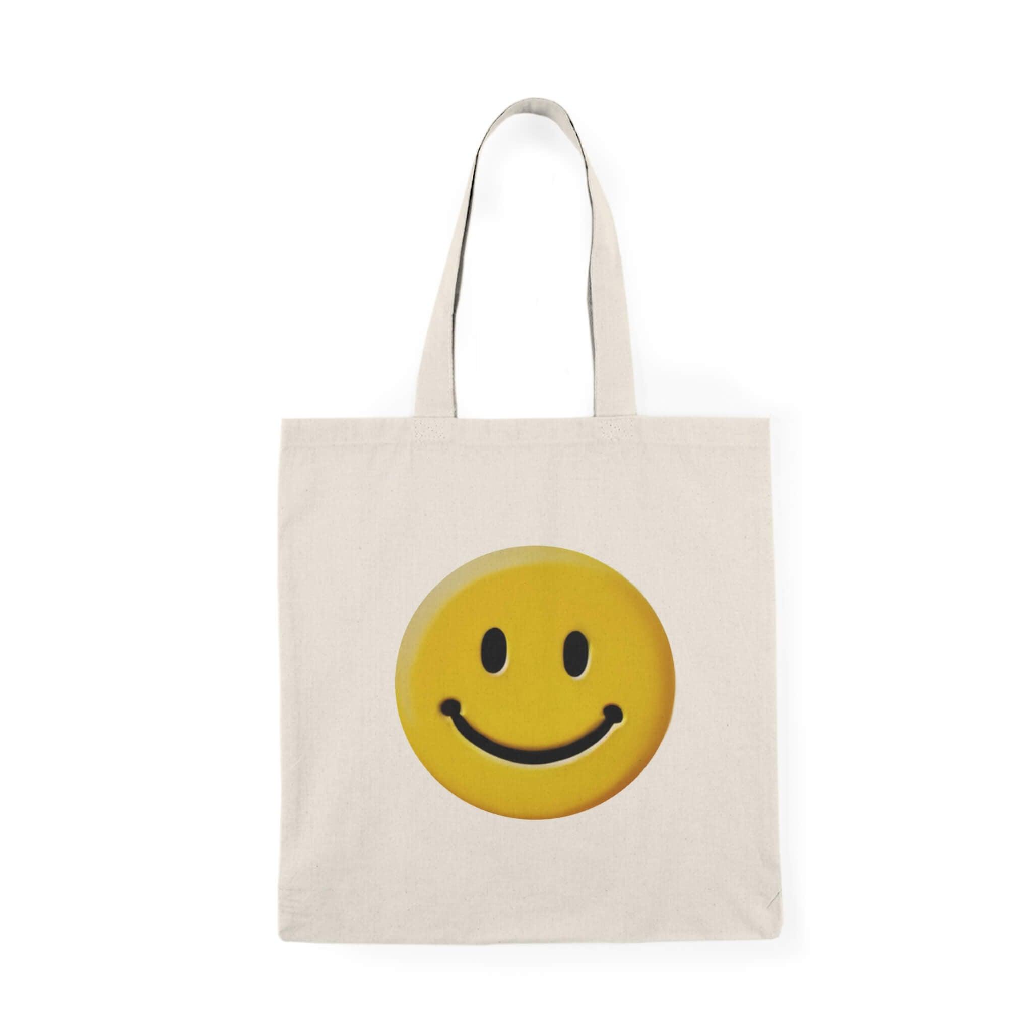 Recycled cotton tote bag featuring a cheerful yellow smiley face, ideal for sustainable and stylish shopping.