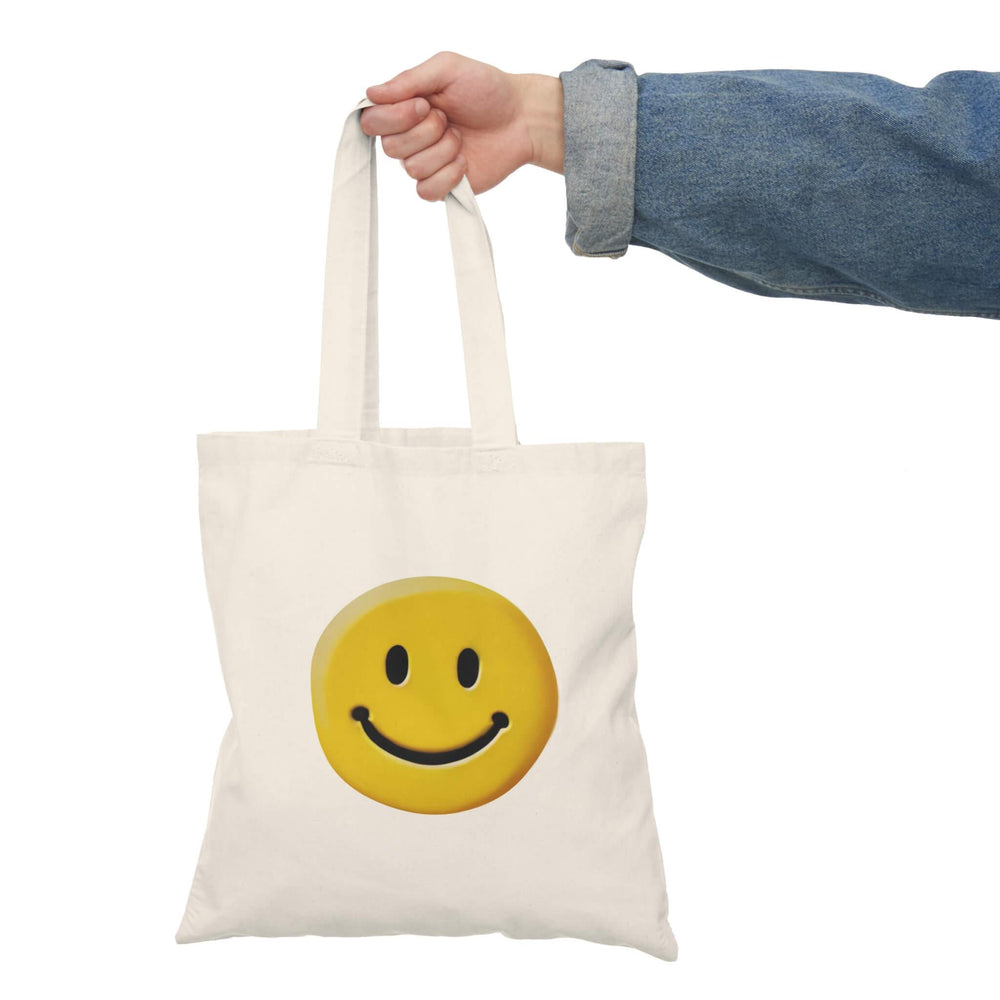 Recycled cotton tote bag featuring a cheerful yellow smiley face, ideal for sustainable and stylish shopping.