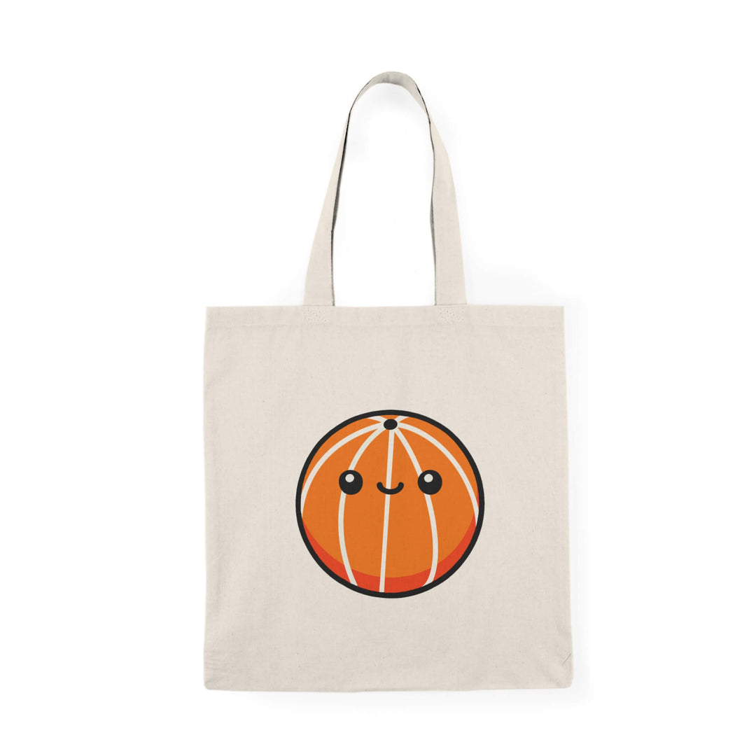 Beige cotton tote bag with a cute cartoon basketball character smiling in the centre.