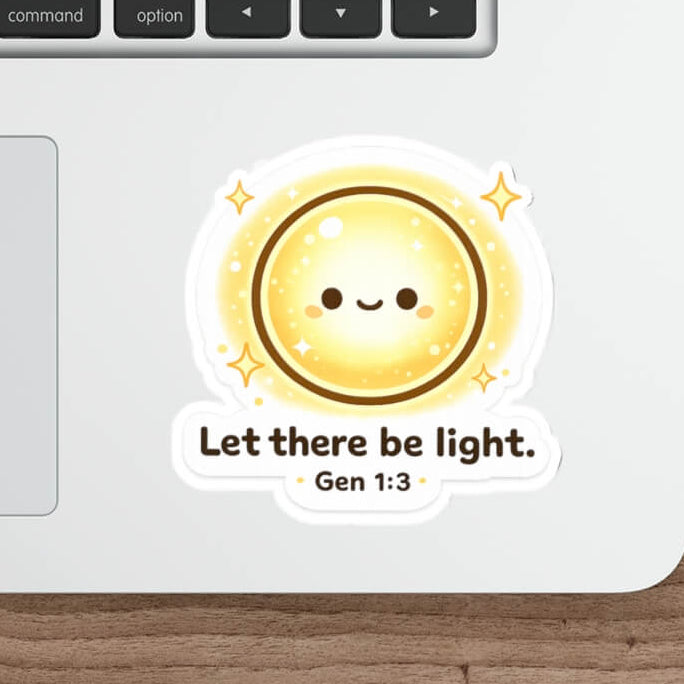 Cute smiling sun sticker with sparkles and the text “Let there be light. Gen 1:3” in kawaii style vinyl decal on a laptop.