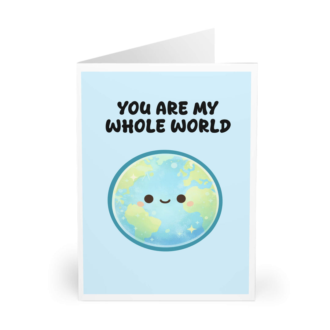 Cute smiling earth illustration on pastel blue background with the phrase “You Are My Whole World,” romantic love greeting card design
