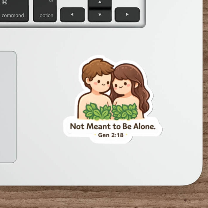 Cute Adam and Eve sticker with leaves and the text “Not Meant to Be Alone Gen 2:18” in kawaii style vinyl decal on a laptop.
