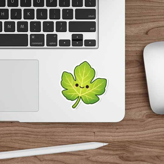 Cute green fig leaf sticker with a smiling face in kawaii style vinyl decal inspired by Genesis.