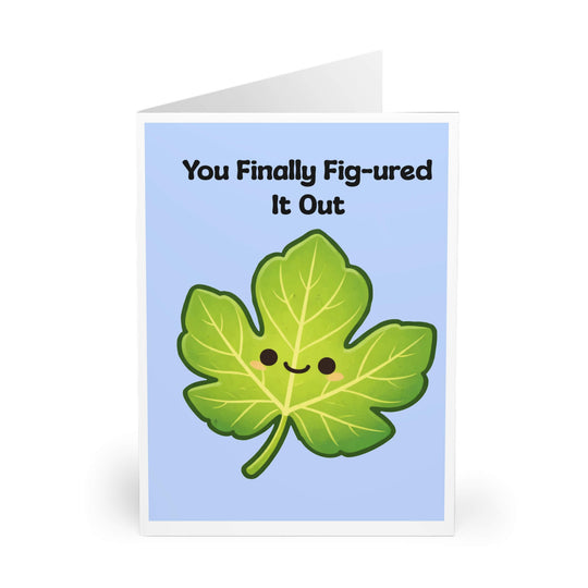 Cute smiling fig leaf illustration on blue background with the phrase “You Finally Fig-ured It Out,” funny congratulations greeting card design