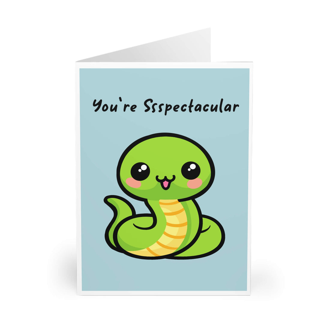 Cute green snake illustration on pastel blue background with the phrase “You’re Ssspectacular,” funny pun greeting card design