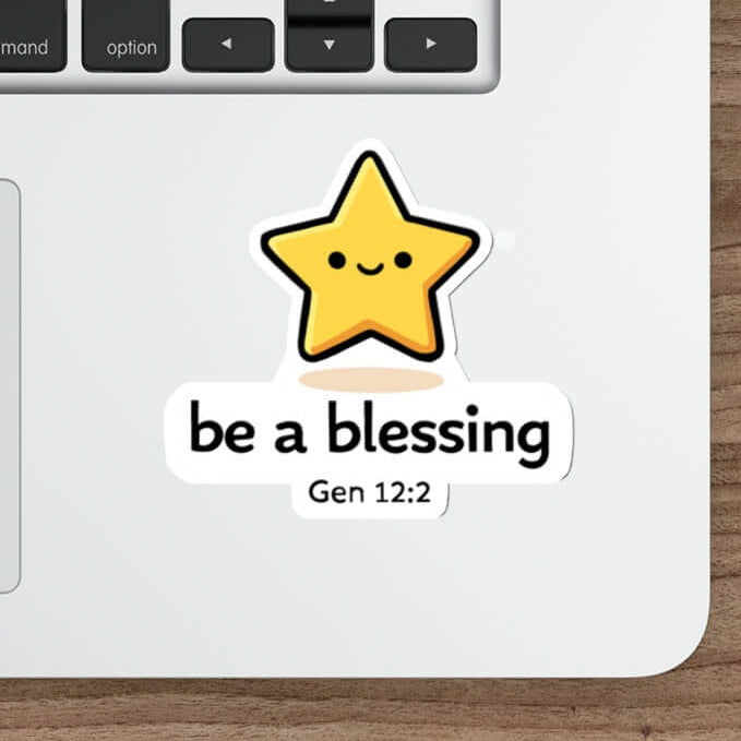 Cute smiling star sticker with the text “be a blessing Gen 12:2” in kawaii style vinyl decal on a laptop.