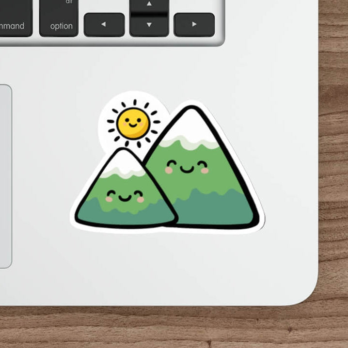 Cute mountain sticker with smiling peaks and sun in kawaii minimalist style