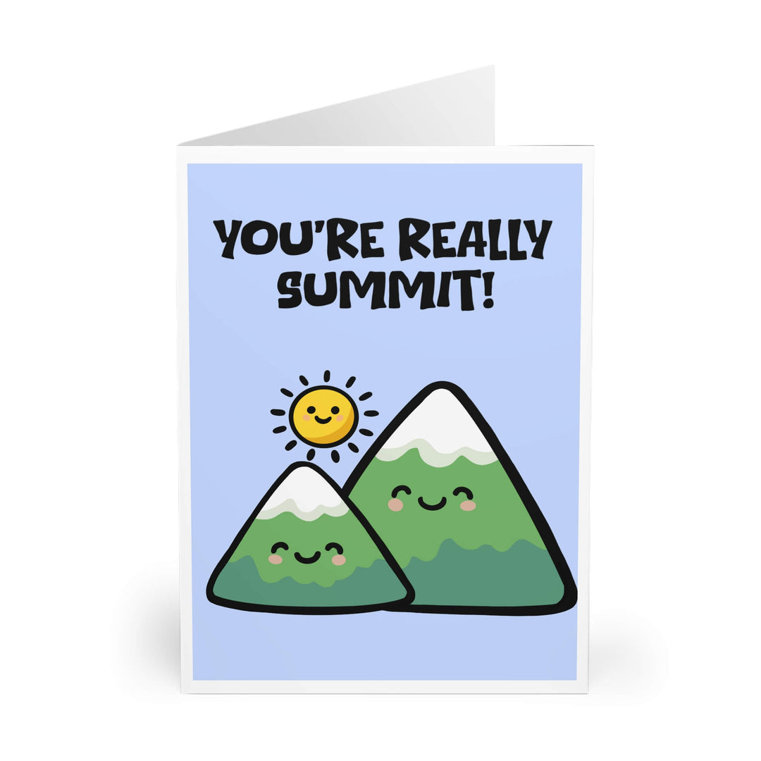 Cute smiling cartoon mountains with snow caps and a happy sun illustration on blue background with the phrase “You’re Really Summit!” pun greeting card