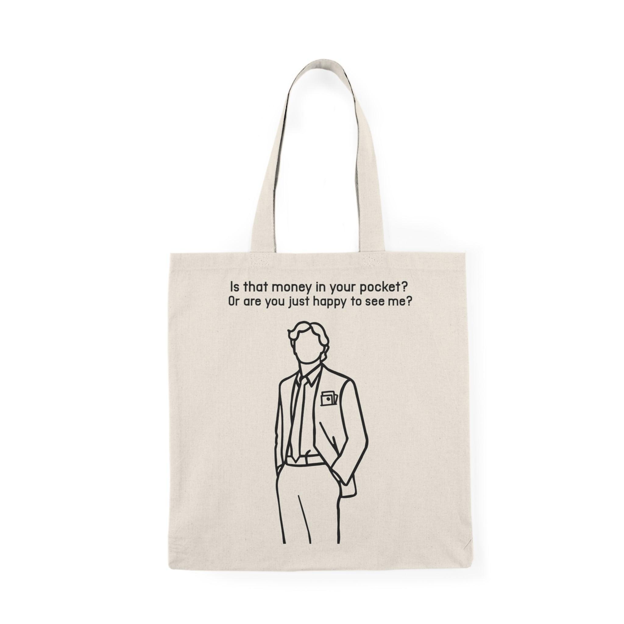 A natural canvas tote bag displaying an illustration of a man in a suit with the text 'Is that money in your pocket?'. The design is both stylish and cheeky, appealing to those who appreciate clever humor in their accessories.