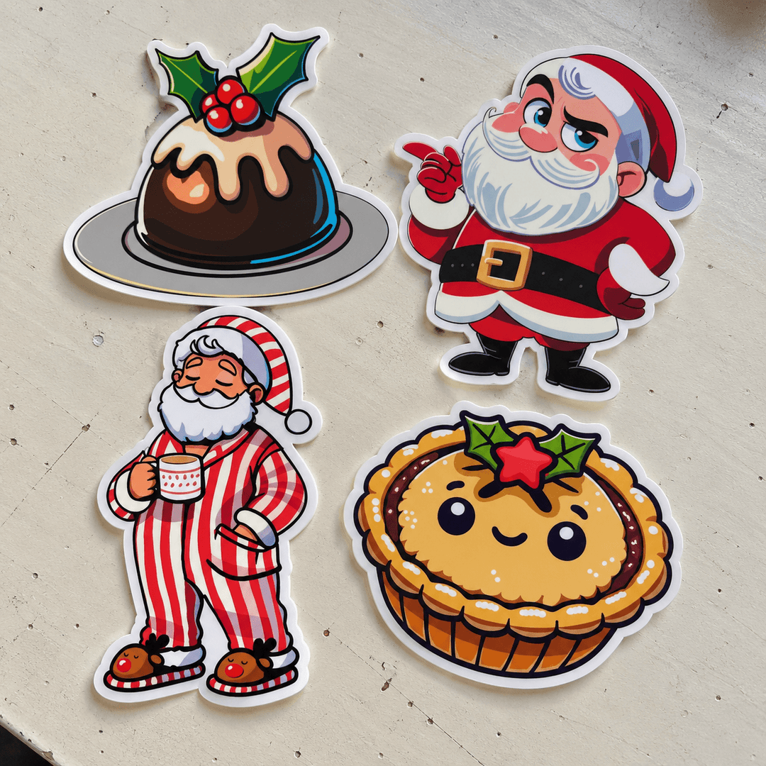 Four Christmas-themed die-cut stickers arranged on a light beige textured surface. The stickers feature a chocolate pudding with holly and red berries, a Santa Claus pointing, a Santa Claus in red-and-white striped pajamas holding a mug, and a cute smiling mincepie tart with a star holly topper.