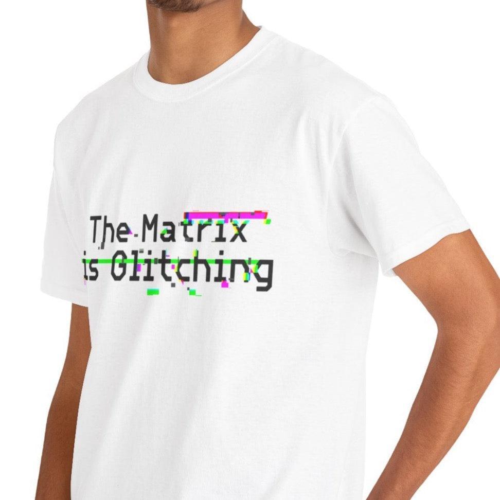 White T-shirt with a glitch-style design of the text 'The Matrix Is Glitching.' A modern, tech-inspired design for those who enjoy the sci-fi world and references to the Matrix.