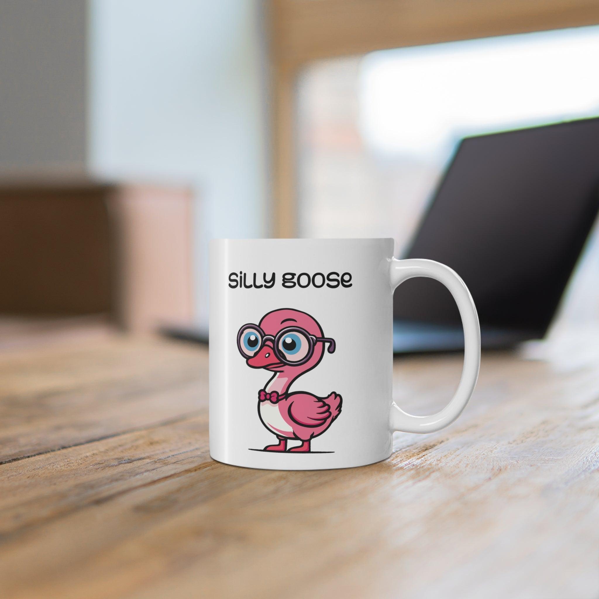 White ceramic mug with a cute and colorful cartoon goose and the phrase 'Silly Goose,' perfect for anyone with a love for playful designs.