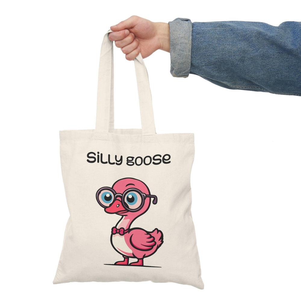 A cream tote bag featuring a playful illustration of a cartoon goose with glasses and the text 'Silly Goose.' The fun design and bright colors capture a lighthearted spirit, making it an excellent accessory for those with a sense of humor."